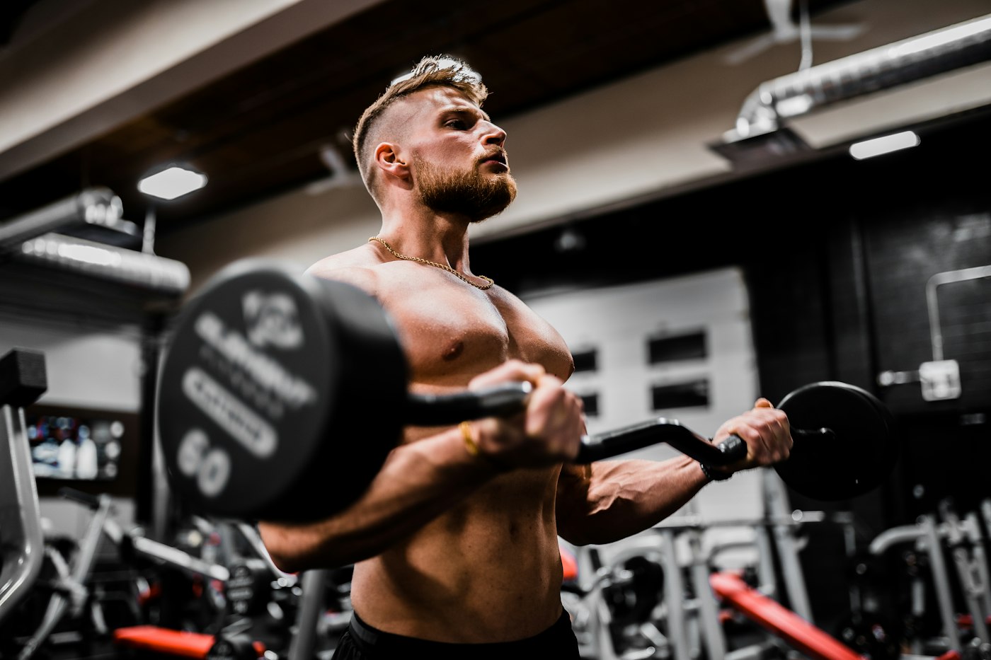 Athlete curling a heavy dumbbell during a strength training session
