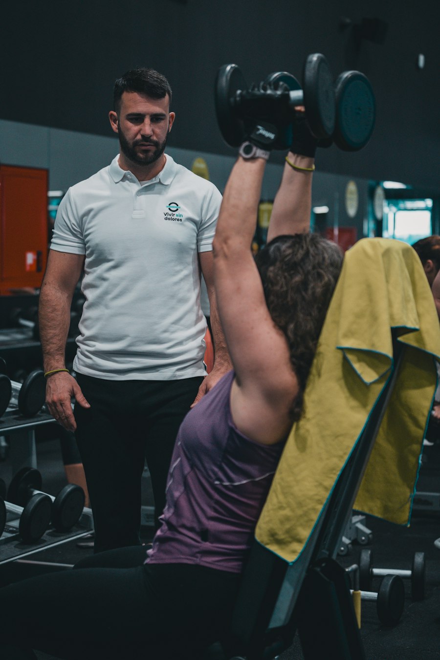 Coach cueing barbell technique during a lift