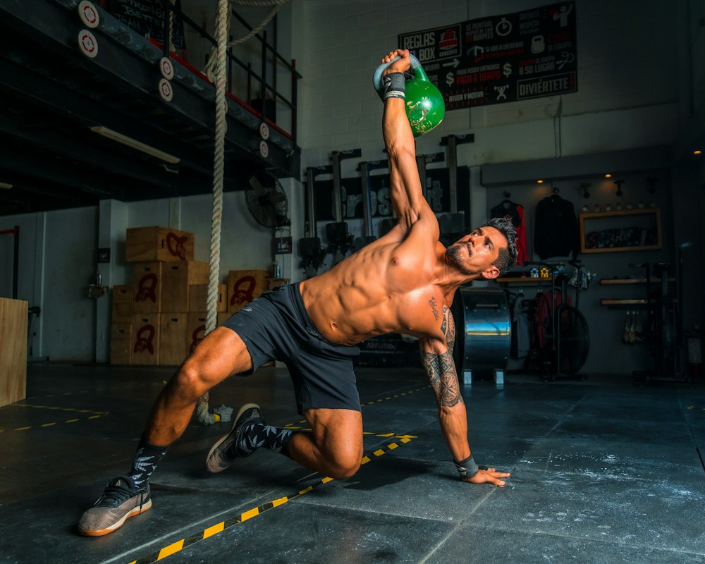 Athlete performing a kettlebell get-up for conditioning