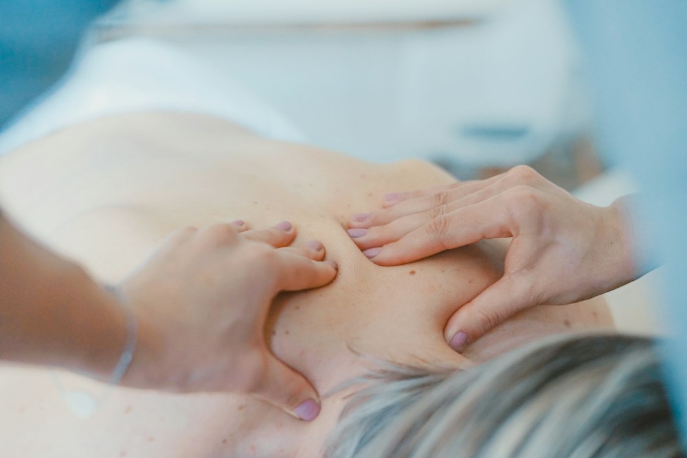 Therapist working on an athlete’s back during a recovery session