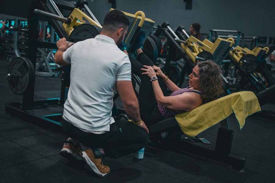 Strength coach supervising a member on a machine
