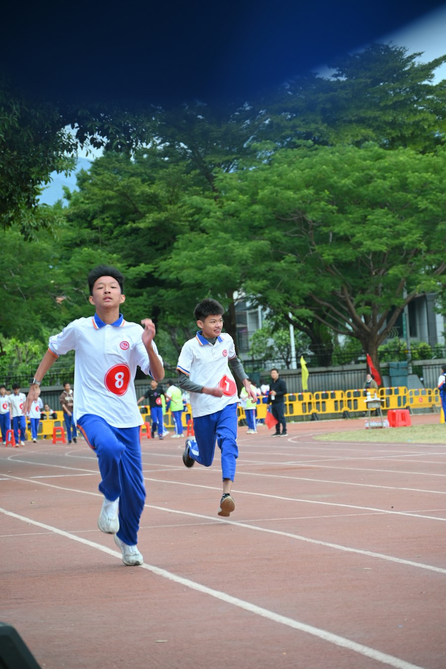 Two young runners racing each other on a track