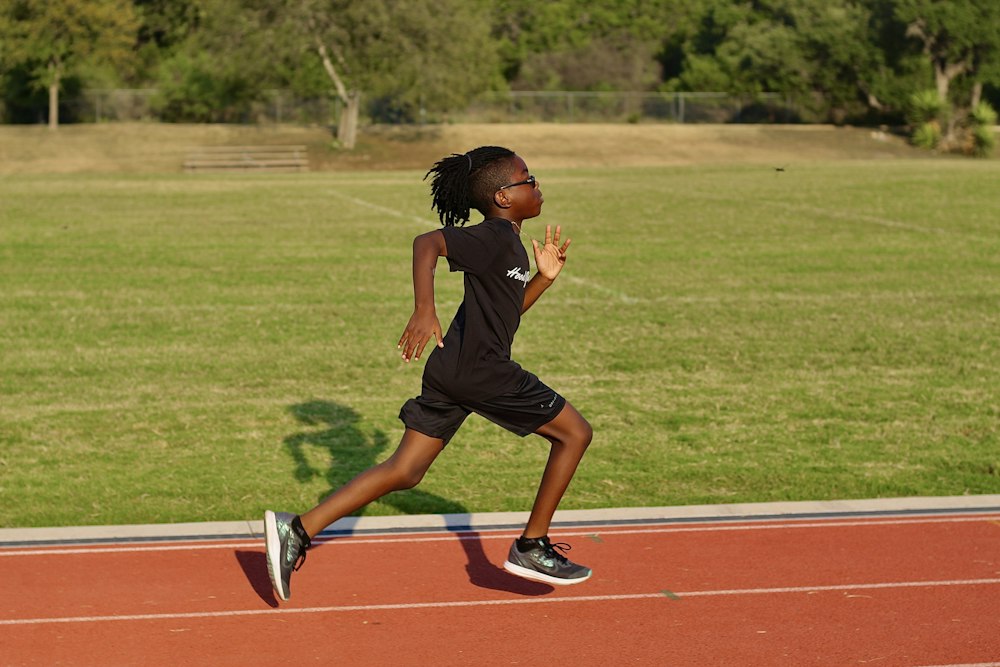 Young athlete running on a track during training