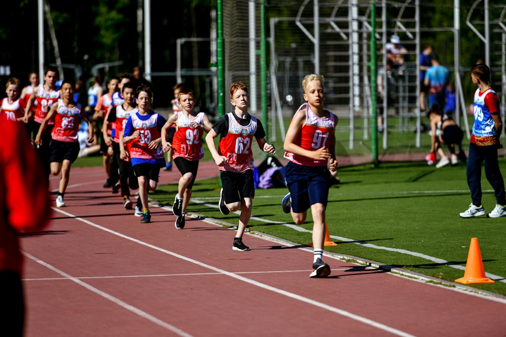 Group of young athletes sprinting on a running track